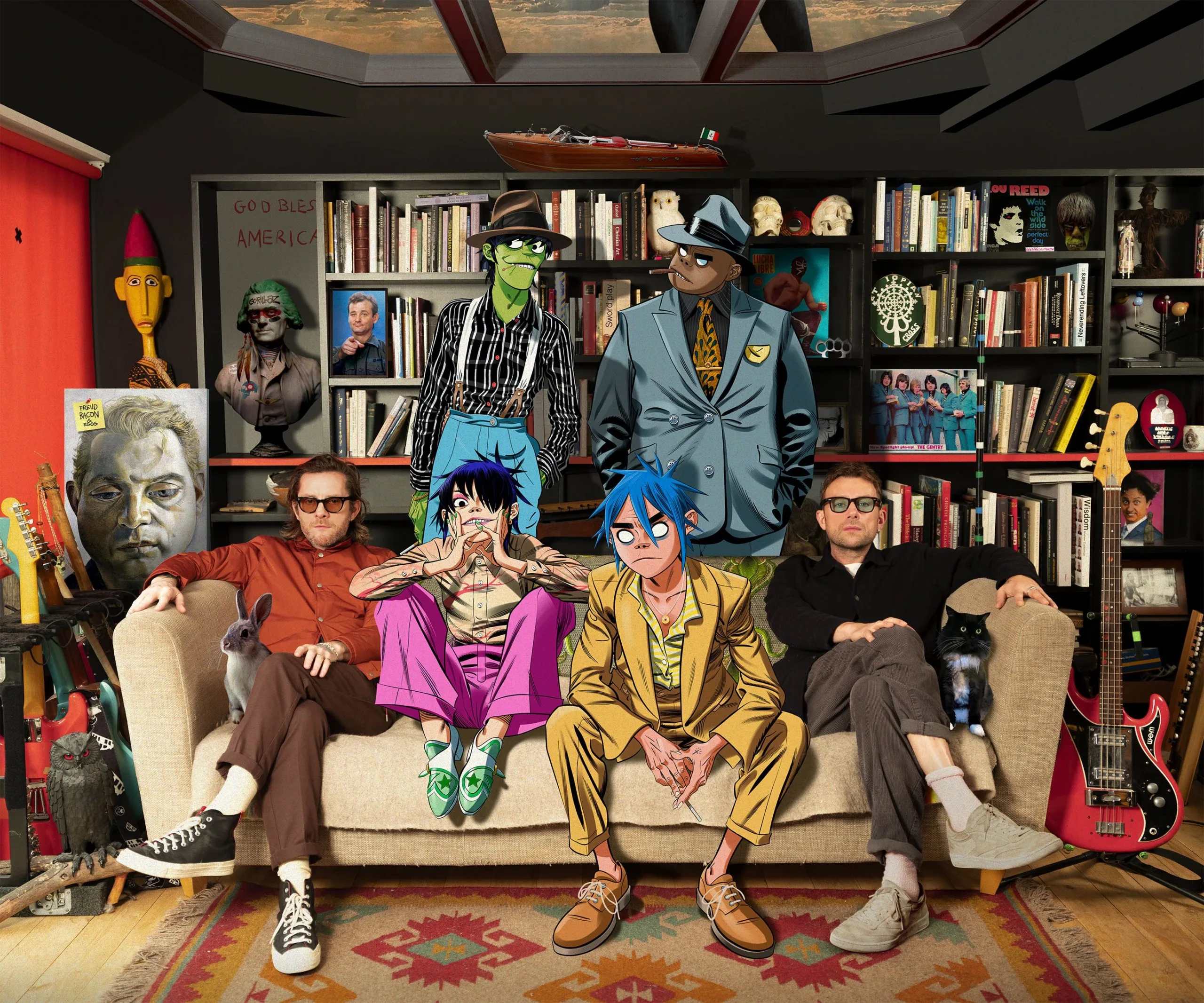 Аніматори Gorillaz та персонажі групи на дивані в студії