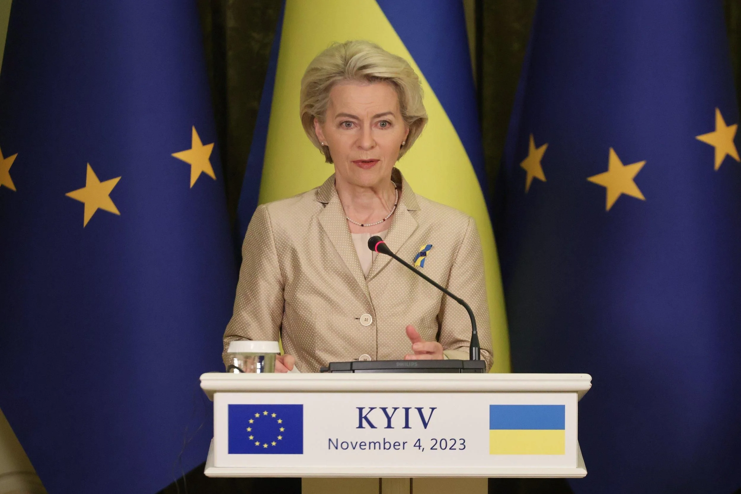 Урсула фон дер Ляєн виступає на подіумі в Києві з прапорами ЄС та України